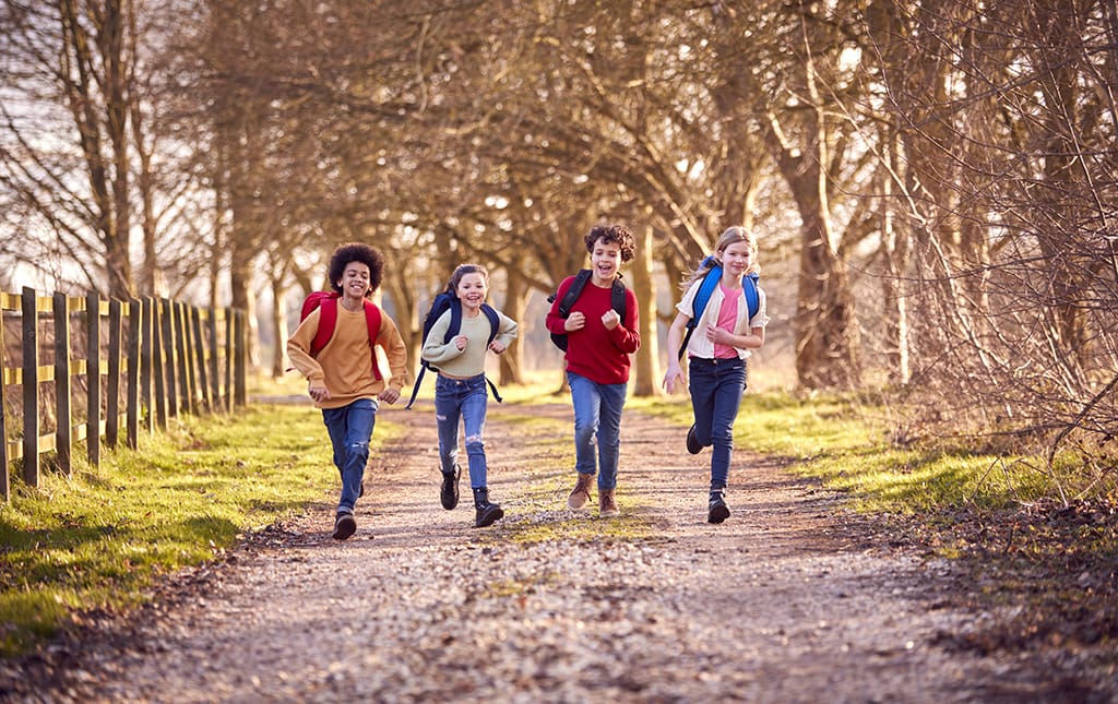 Kids jogging on an outdoor track during a jog-a-thon