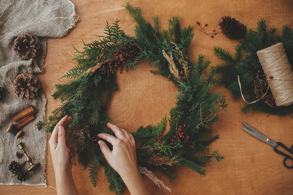 Wreath being decorated for sale during December school fundraiser event