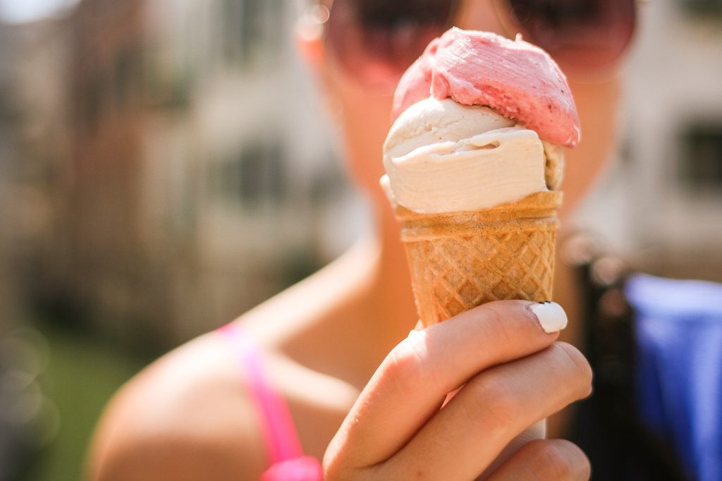 Person eating an ice cream cone from an ice cream truck fundraiser