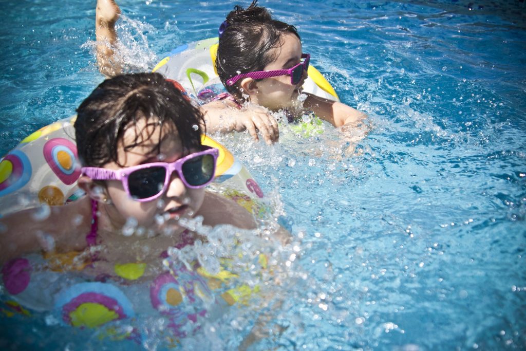 Kids swimming at a pool party fundraiser