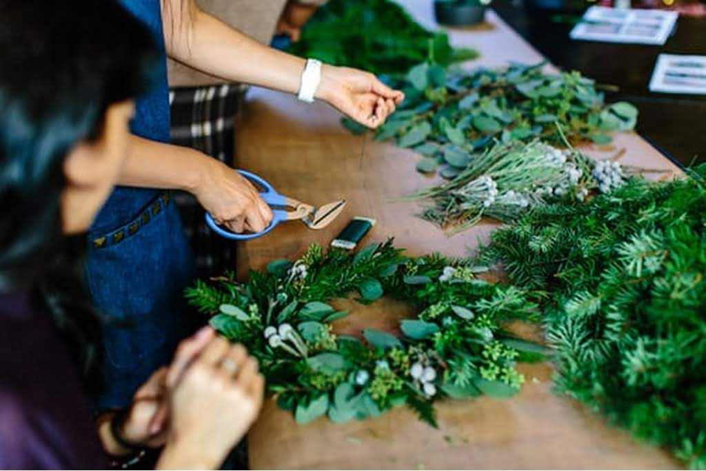 two friend making wreaths