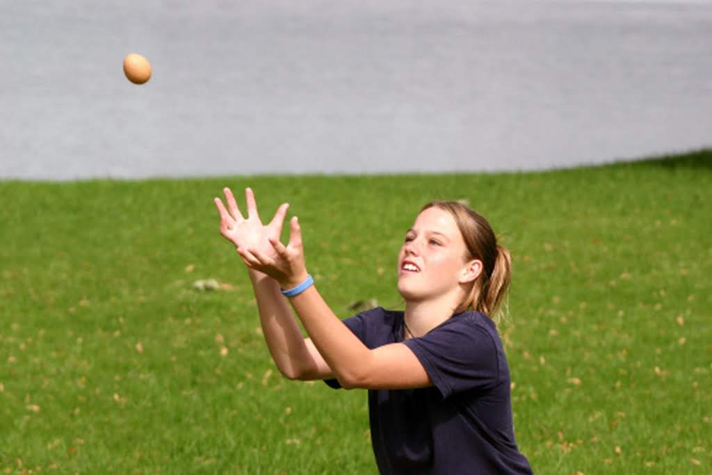 child playing in an egg toss