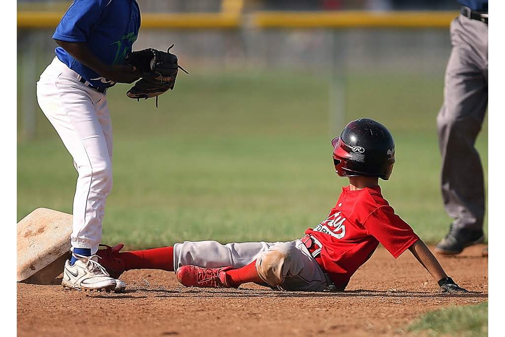 kid sliding to home plate in baseball