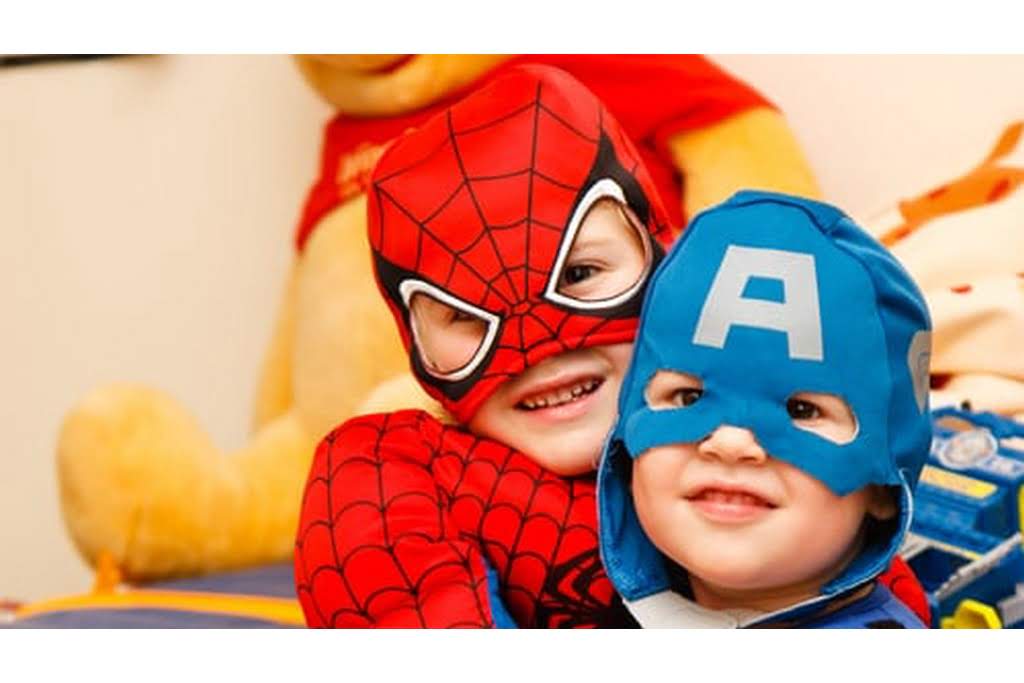 two kids in costumes having fun