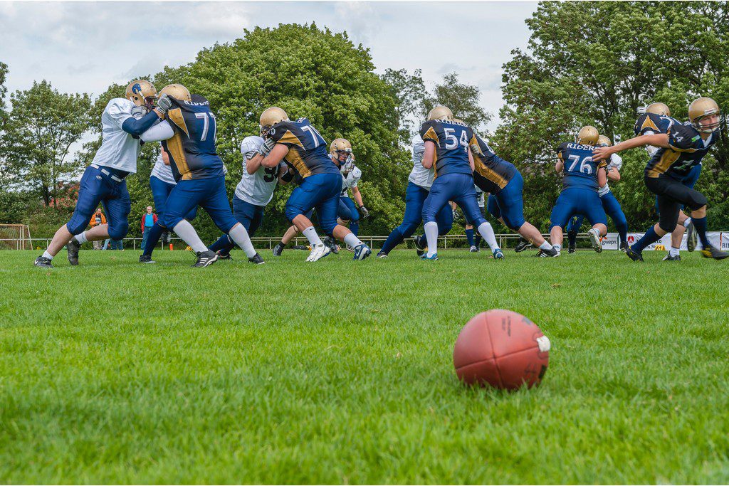 a high school football team on the field in the middle of a scrimmage
