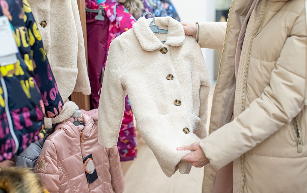 A volunteer looks over children's winter gear during a donation drive for needy students.