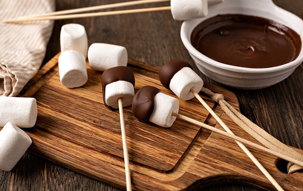 Chocolate covered marshmallows being prepared for a school fundraiser.