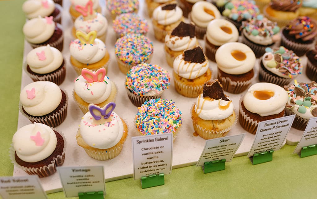 Cute cupcakes at a cupcake war sale, complete with recipe cards