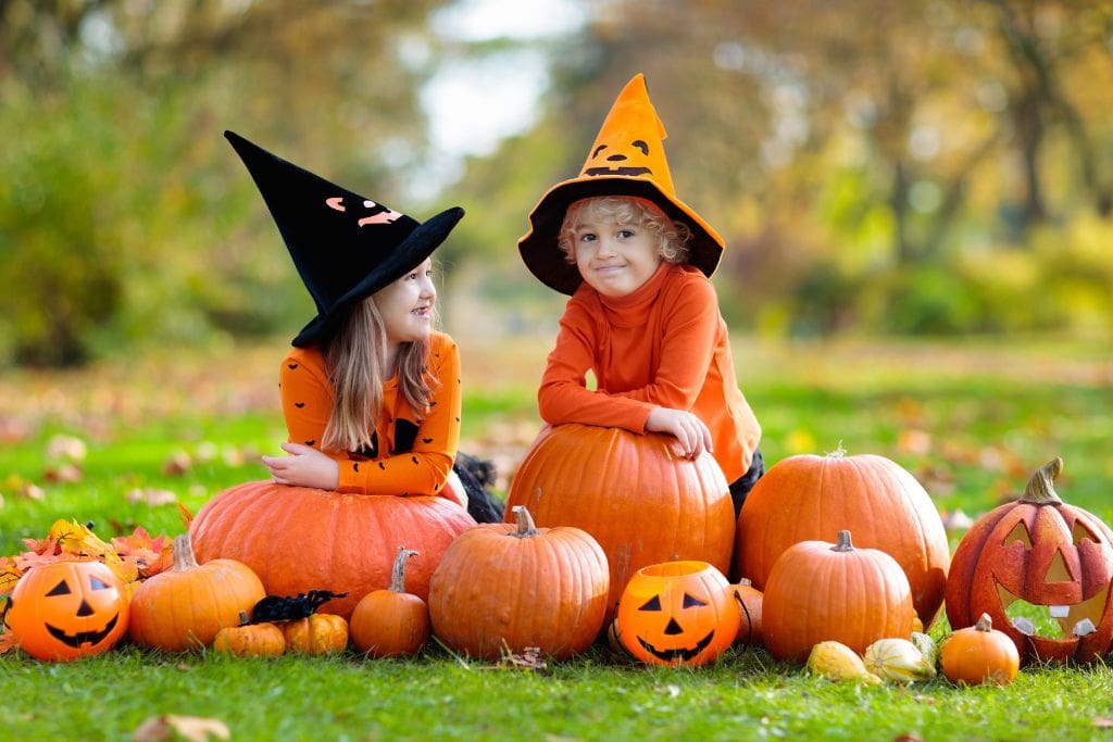 2 kids in a pumpkin patch
