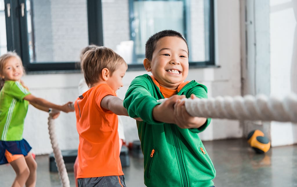 School children playing tug of war