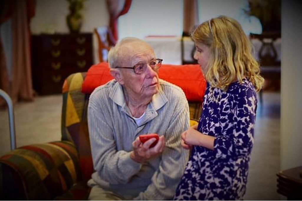 granpa and grandaughter sharing a moment