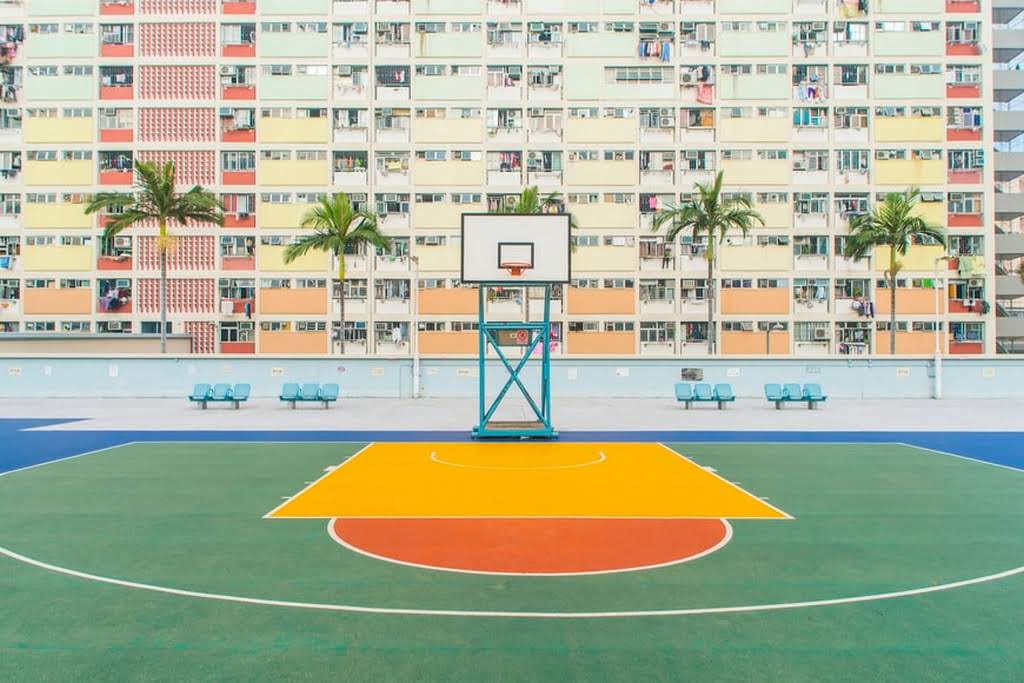 An empty basketball court with colorful orange and yellow patterns