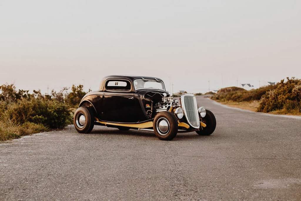 A 1950s classic car on a road