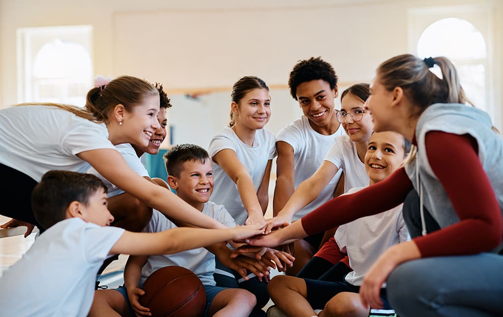 School kids celebrating March Madness during a school basketball game.