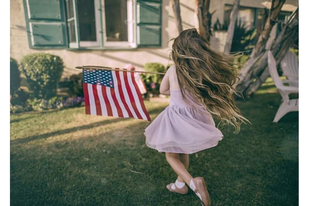 littler girl holding American flag