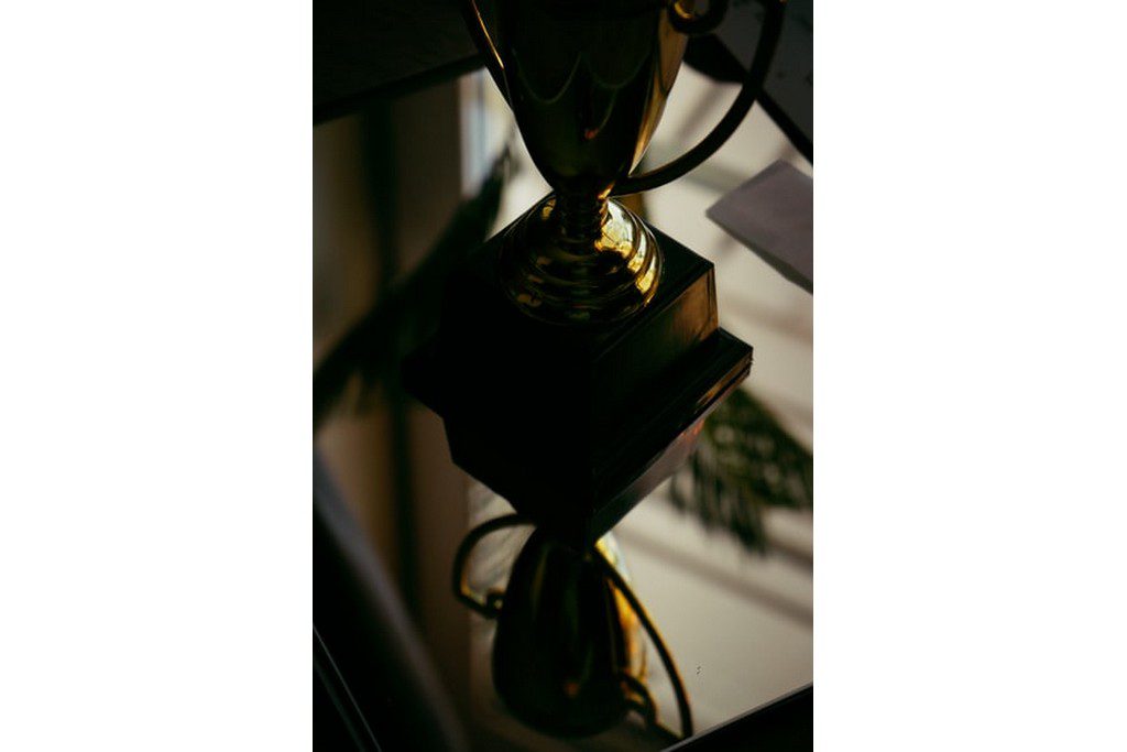 A dark picture of a gold trophy championship trophy