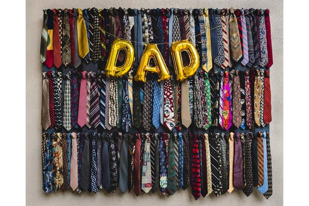 a tie rack with dad in balloons
