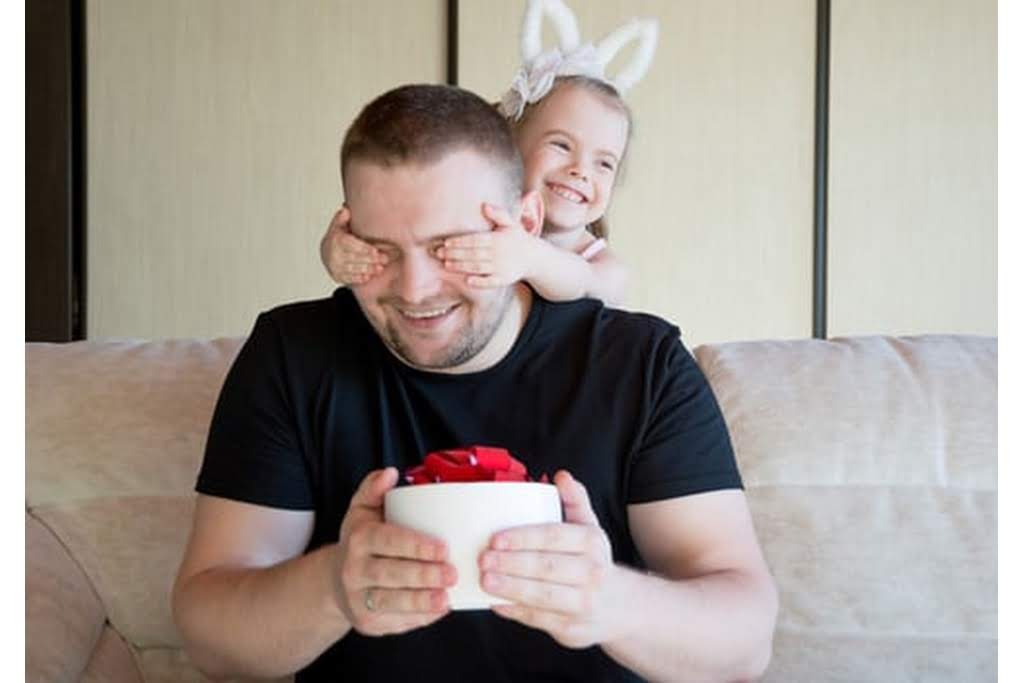 kid playing peek a boo with dad