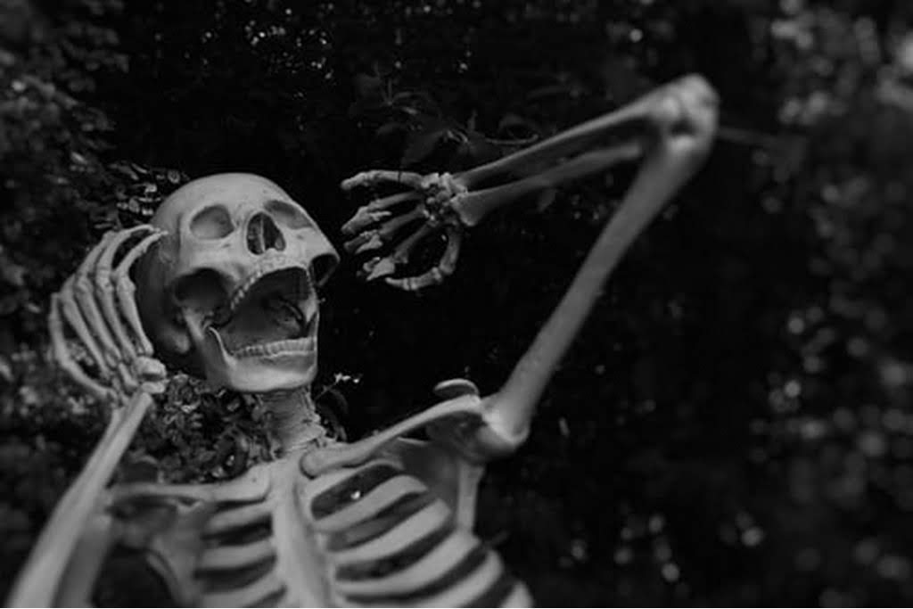skeleton with hands on his head