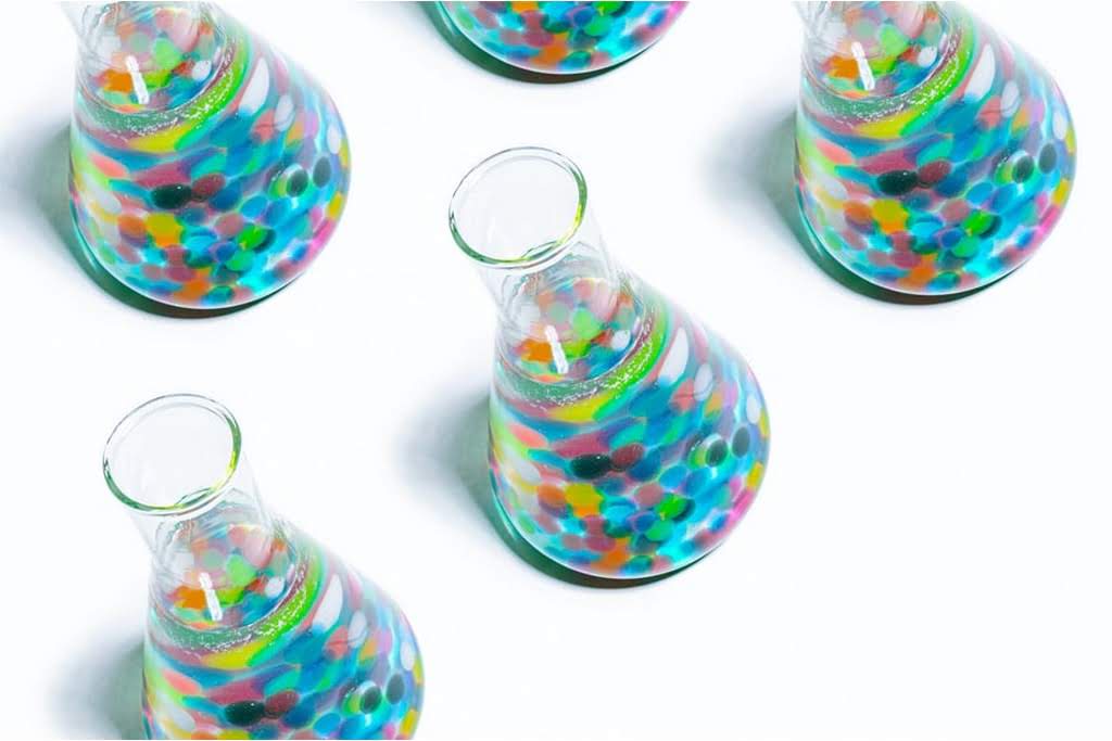 Colorful beakers filled with a clear liquid