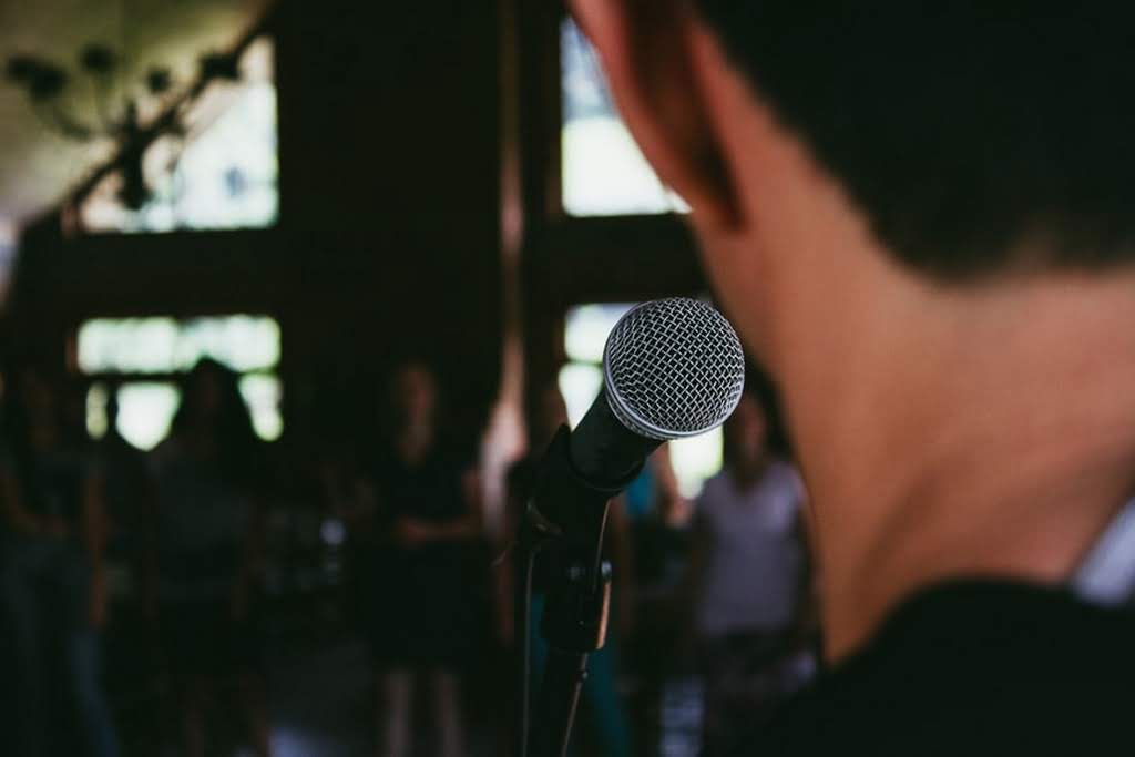 A man in front of a mic