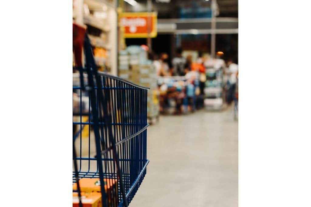 A black shopping cart in a grocery store shopping cart in a hardware store