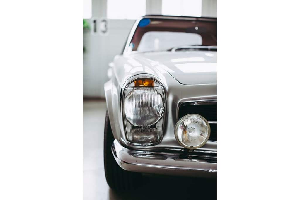 An older white car old muscle car