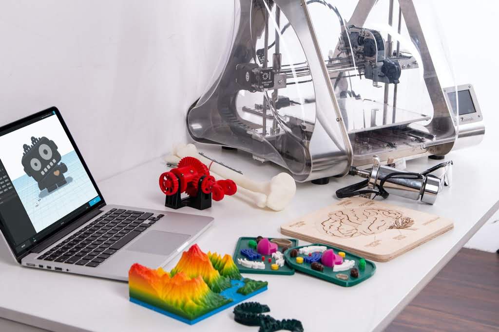 A white desk with 3D printed landscapes and puzzles school project on a desk