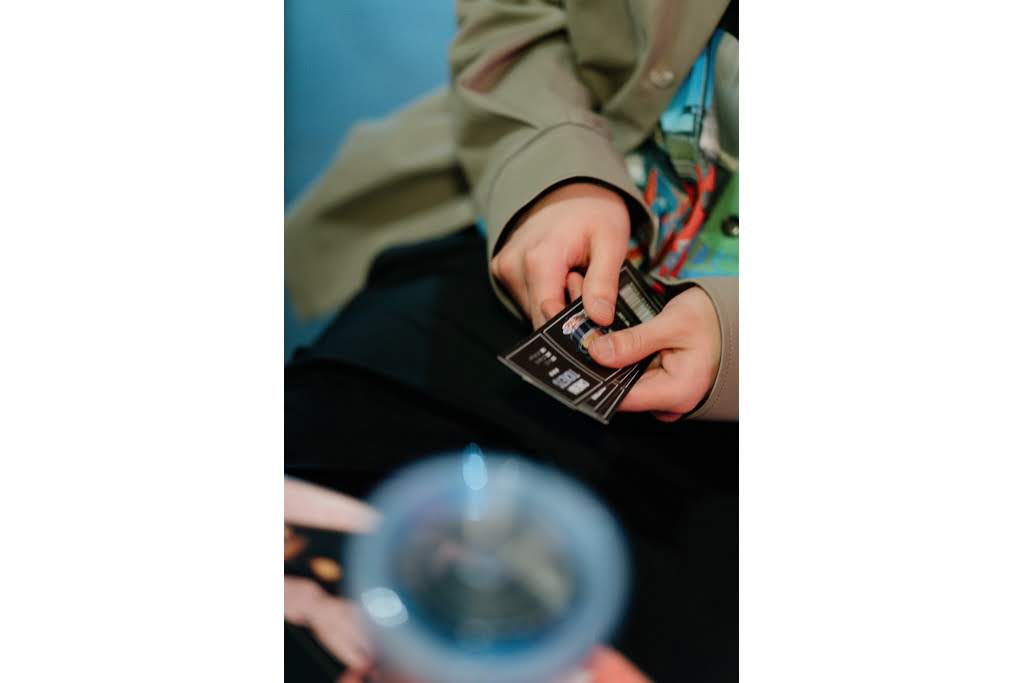 A hand holding tickets tickets to the event