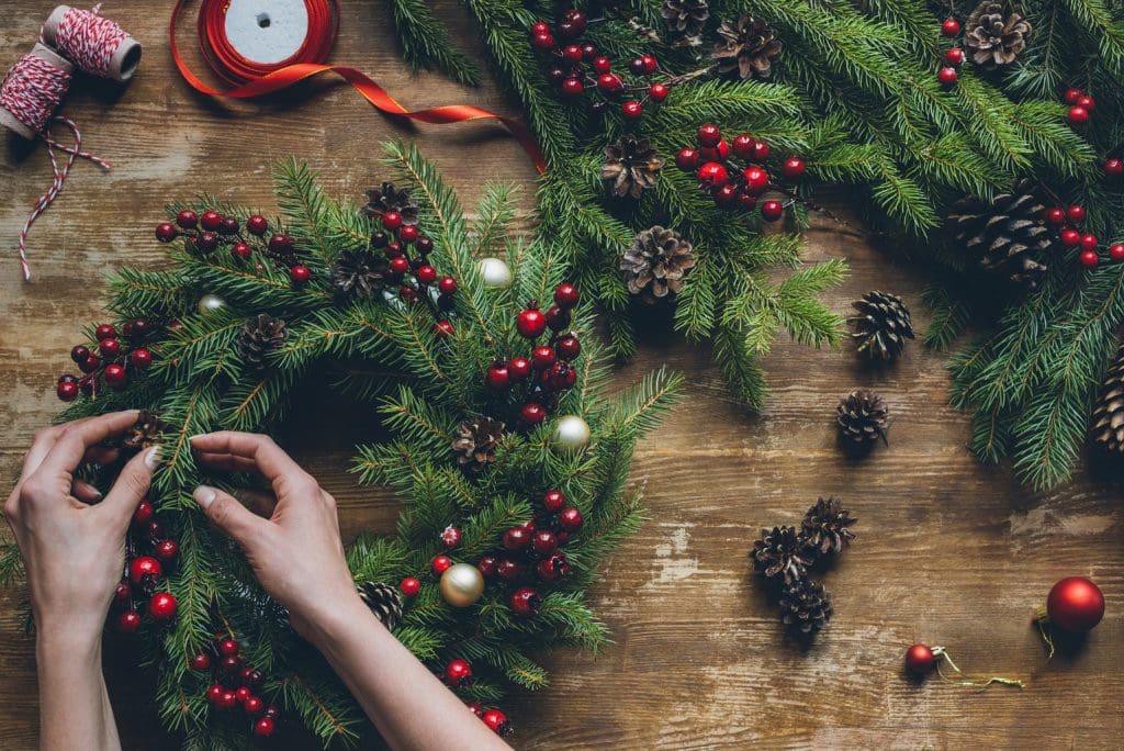 Student preparing wreath for Christmas wreath auction fundraiser