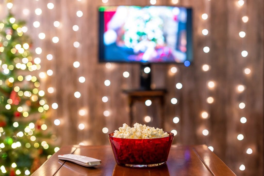 Christmas movie playing on TV in background for school fundraiser event