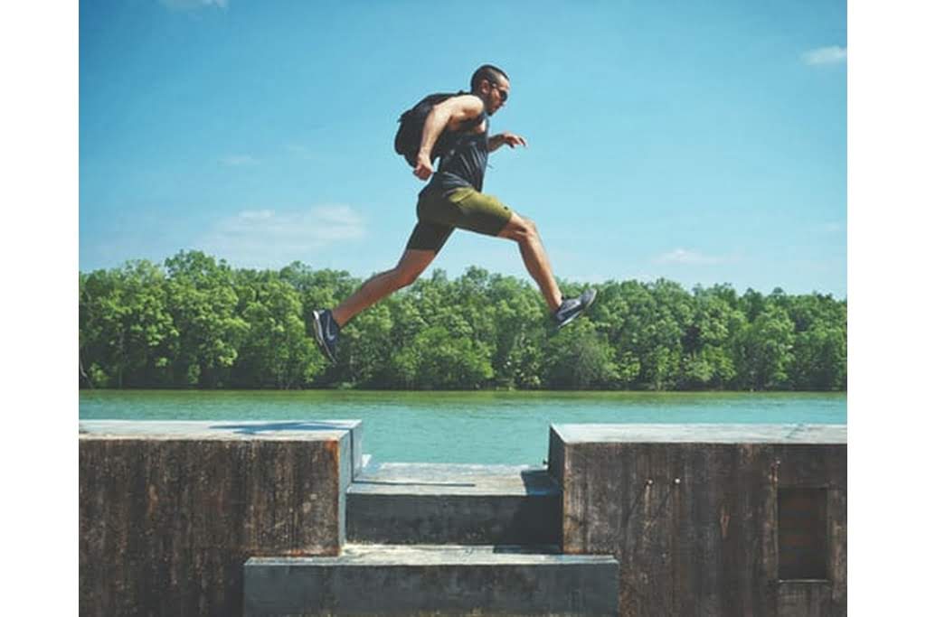 man jumping across gap