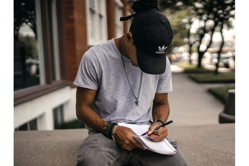 teenager writing in notebook