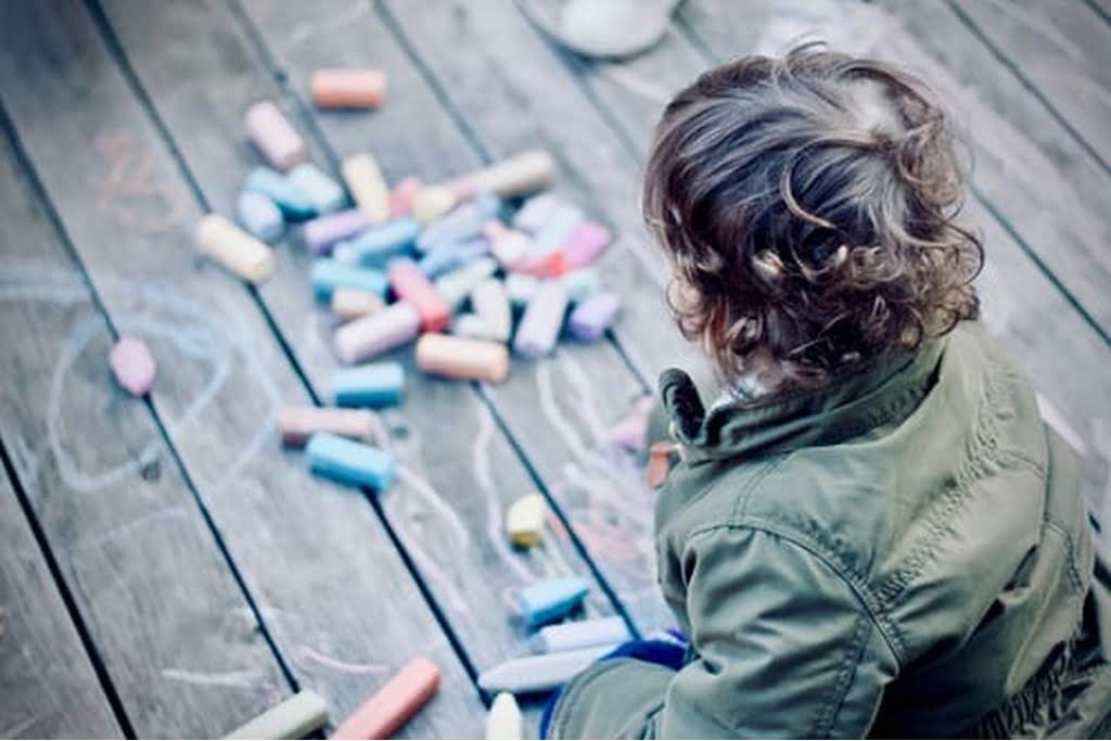 kid playing with chalk