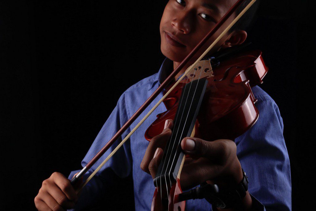 A Southeast Asian teen playing a violin man playing violin