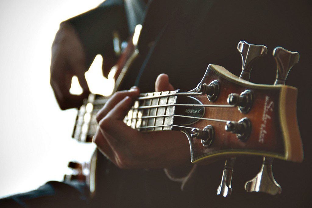 A person strums a guitar palying a guitar guitar