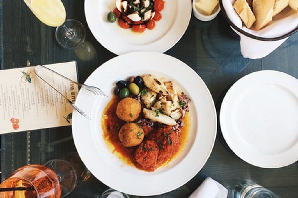 A table with white plates that have food on them dinner dish on table