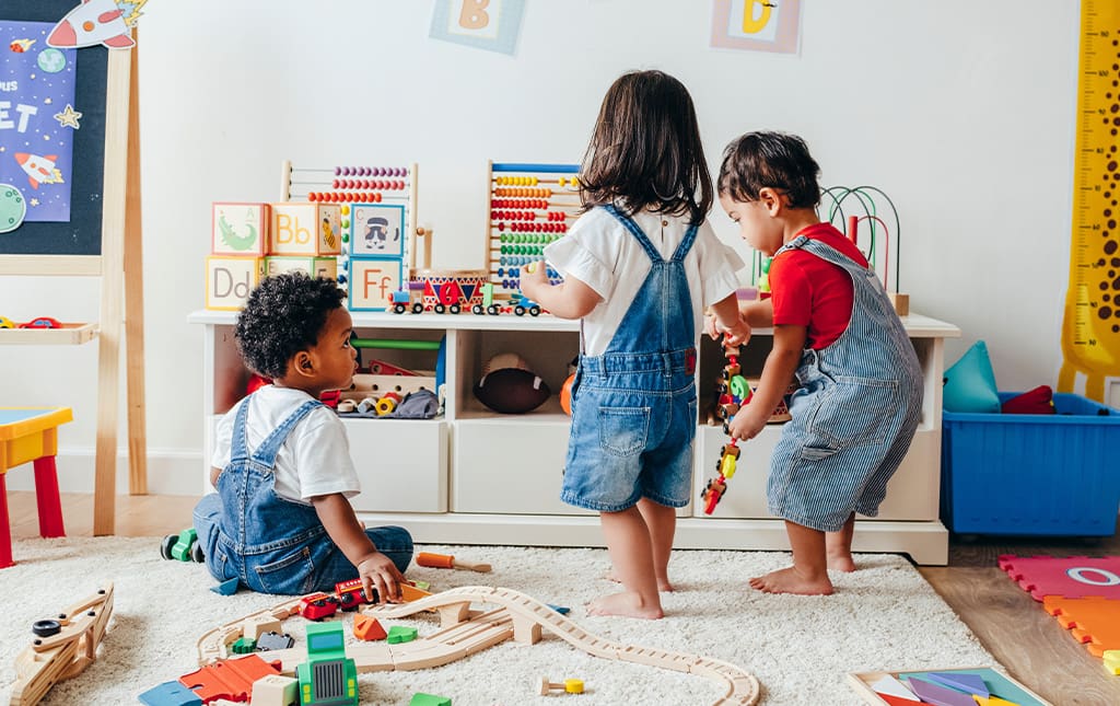 Pre-school students playing together and interacting in classroom