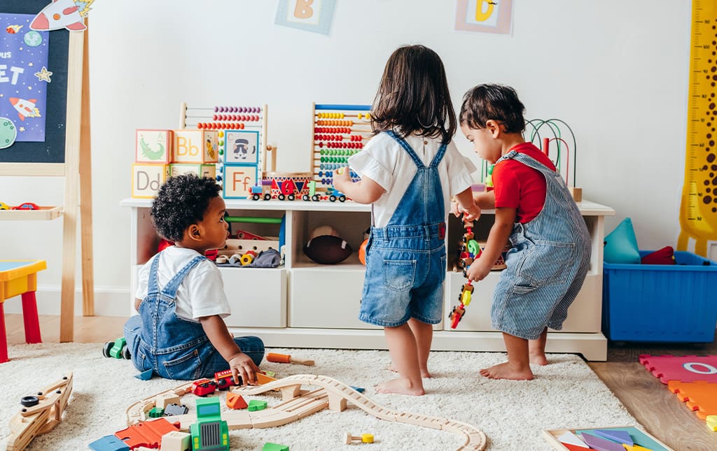 Pre-school students playing together and interacting in classroom 