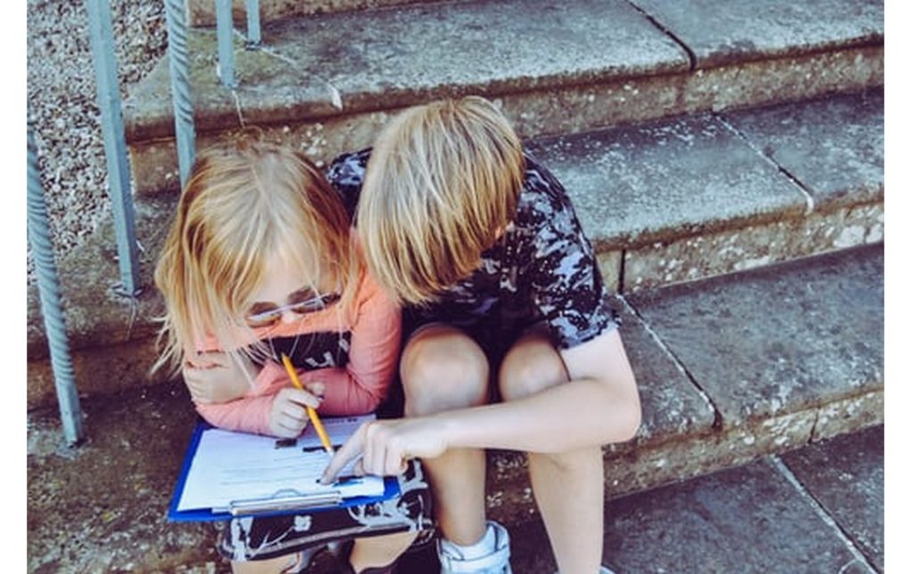 two kids checking their checklist