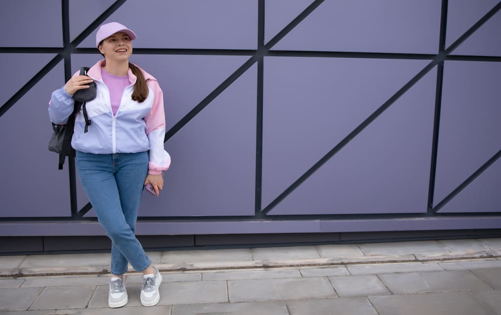 Woman Dresses in 90's attire with Windbreaker and Sneakers