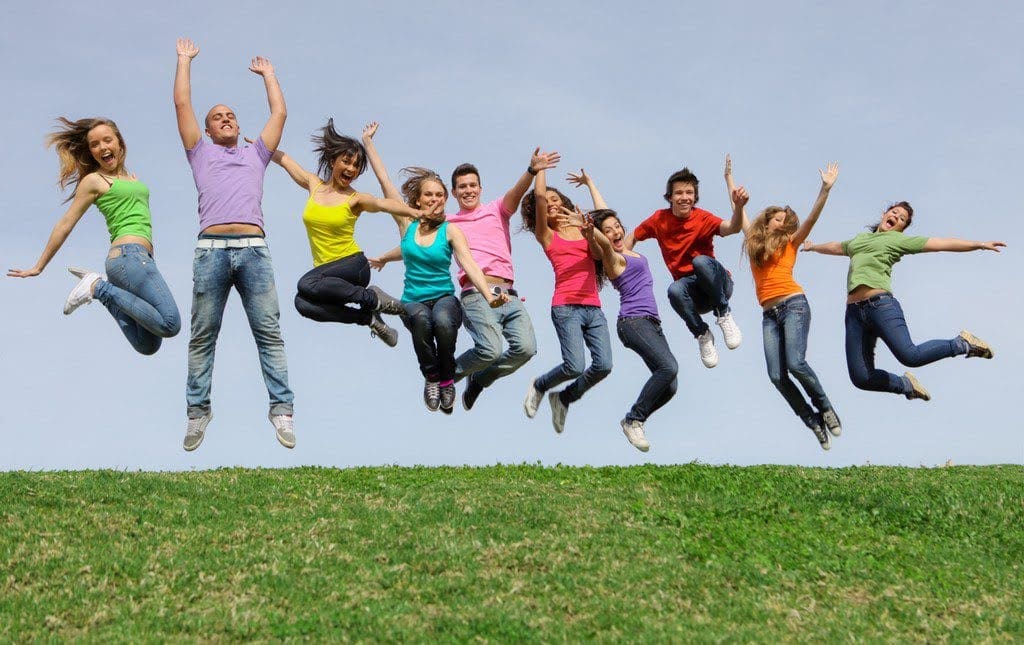 Teenage students snap a picture during a jump-a-thon on school grounds.