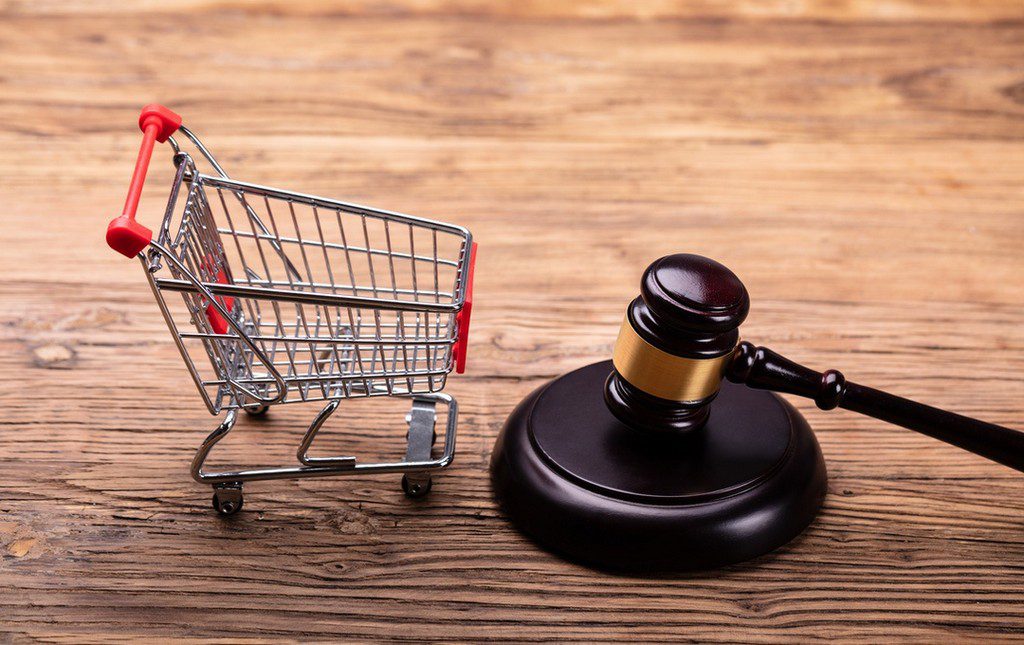 Shopping cart next to gavel to symbolize unique compliance requirements of purchase product fundraisers