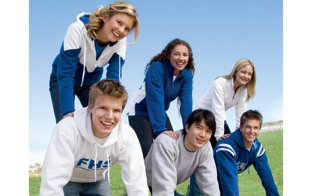 Students wearing school spirit sweatshirts