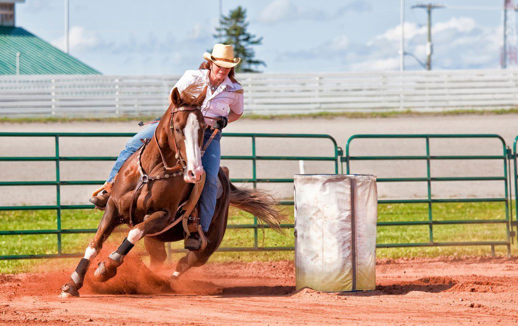 Woman racing her horse at the rodeo