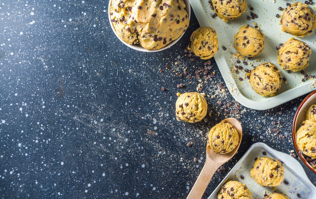 Cookie dough being prepared into balls on a table