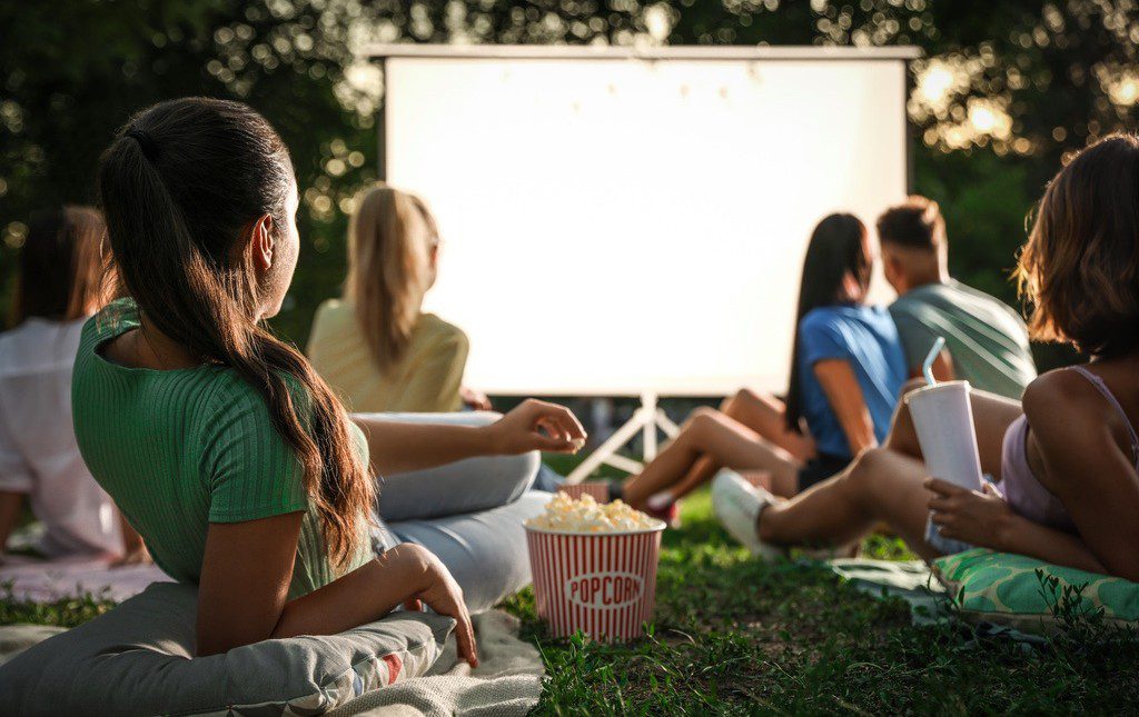 Students at open-air movie night for end of school year party