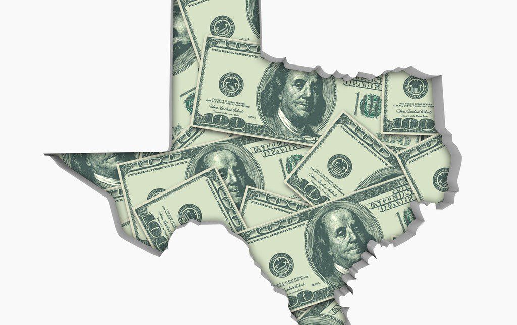 US dollar bills in the shape of the State of Texas