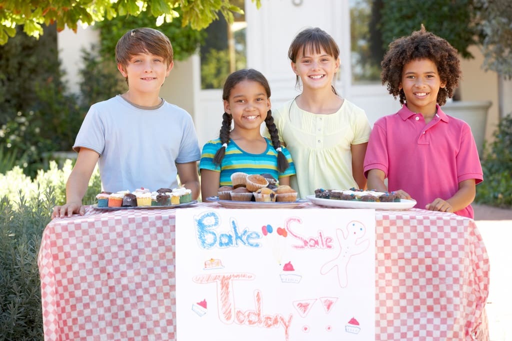Students at table for bake sale school fundraiser