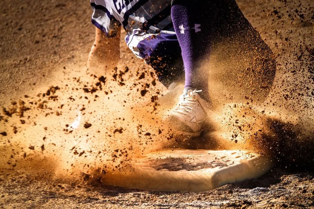 Baseball player sliding into base during a fundraiser